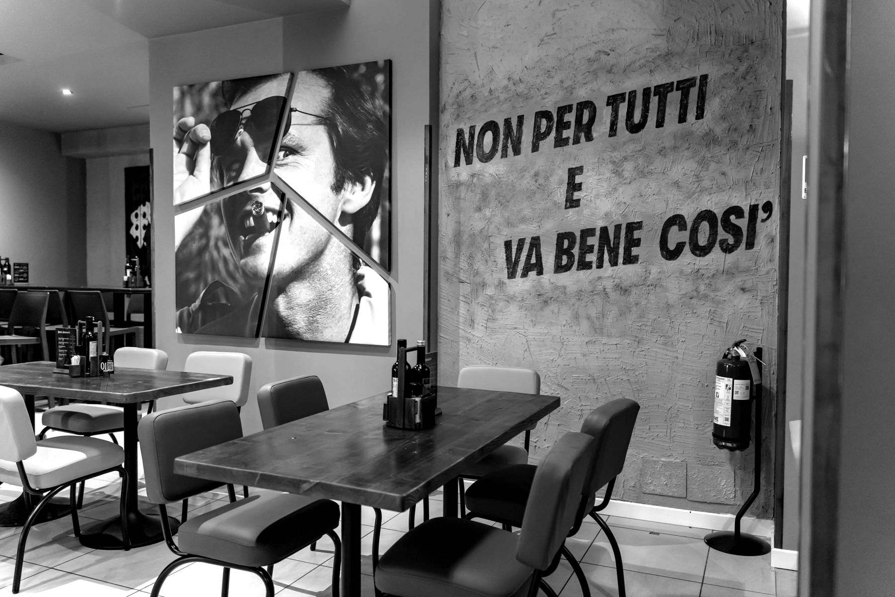 La sala con la scritta Non per tutti e va bene così sul muro di cemento